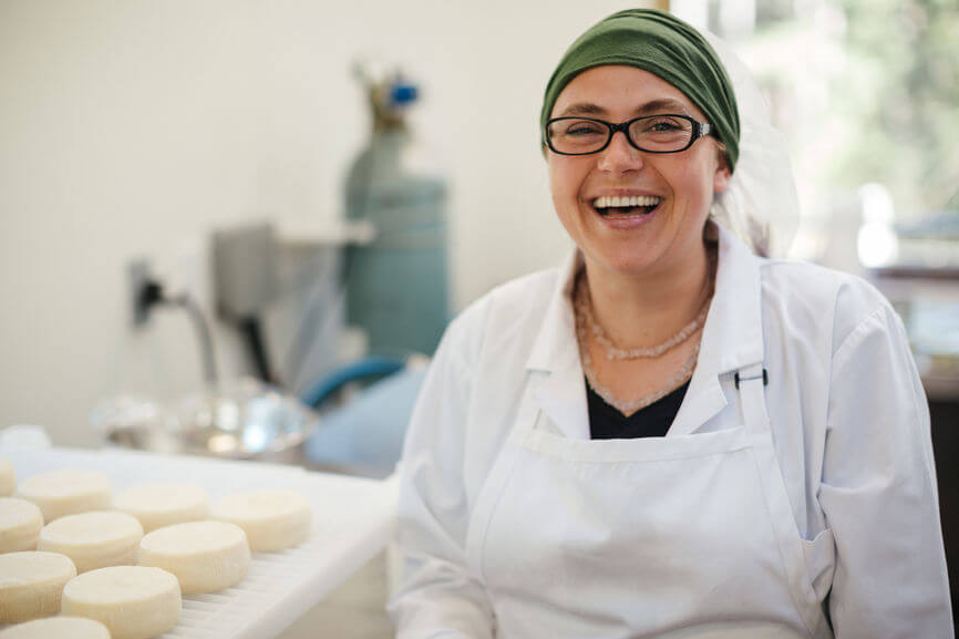 Woman smiling, working in a bakery